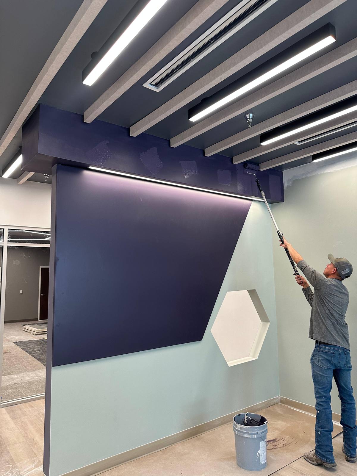 Painter rolling an interior wall